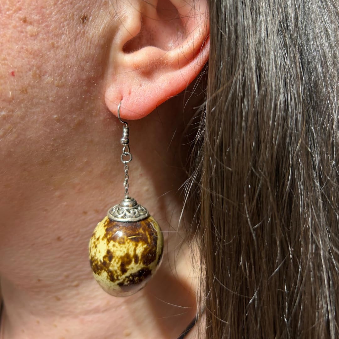 Brown Quail Egg Earrings in a woman's ear