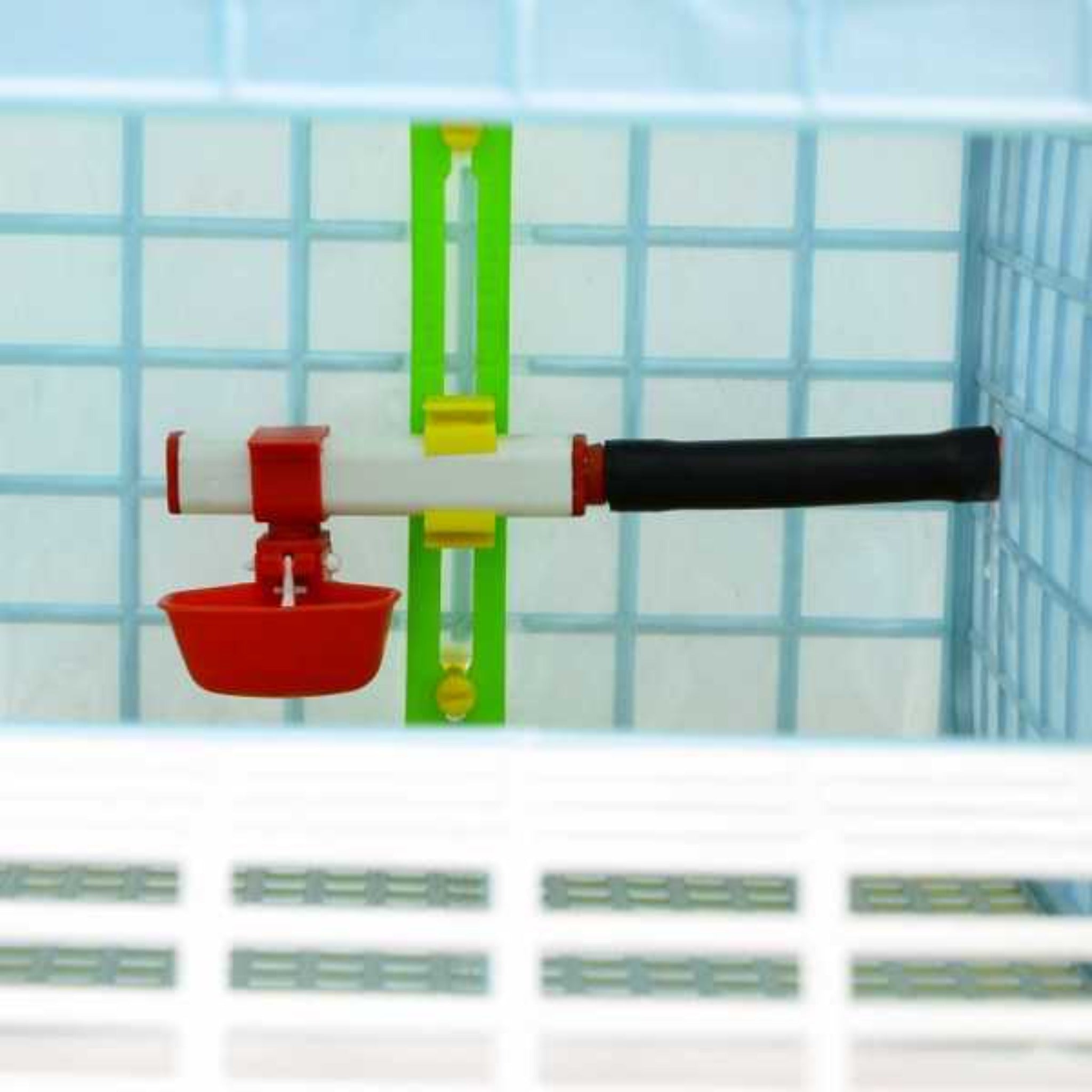 Cimuka plastic poultry grow-out cage with Comfortplast elliptical flooring and automatic nipple drinkers.
