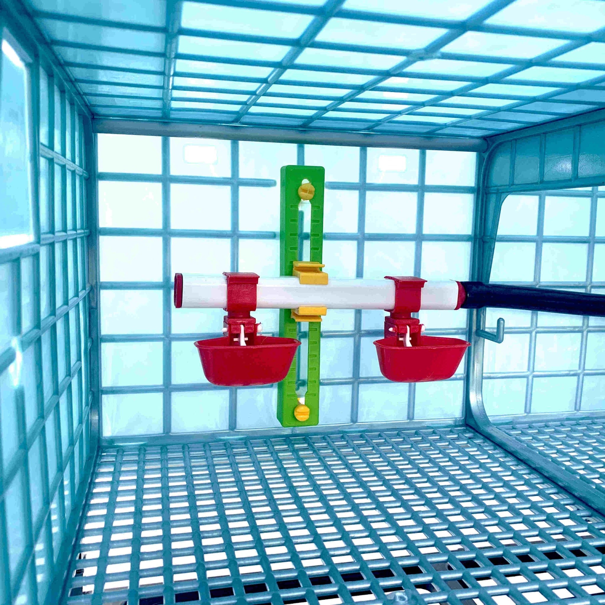 Stackable poultry grow-out cage with removable manure trays and automatic nipple drinkers