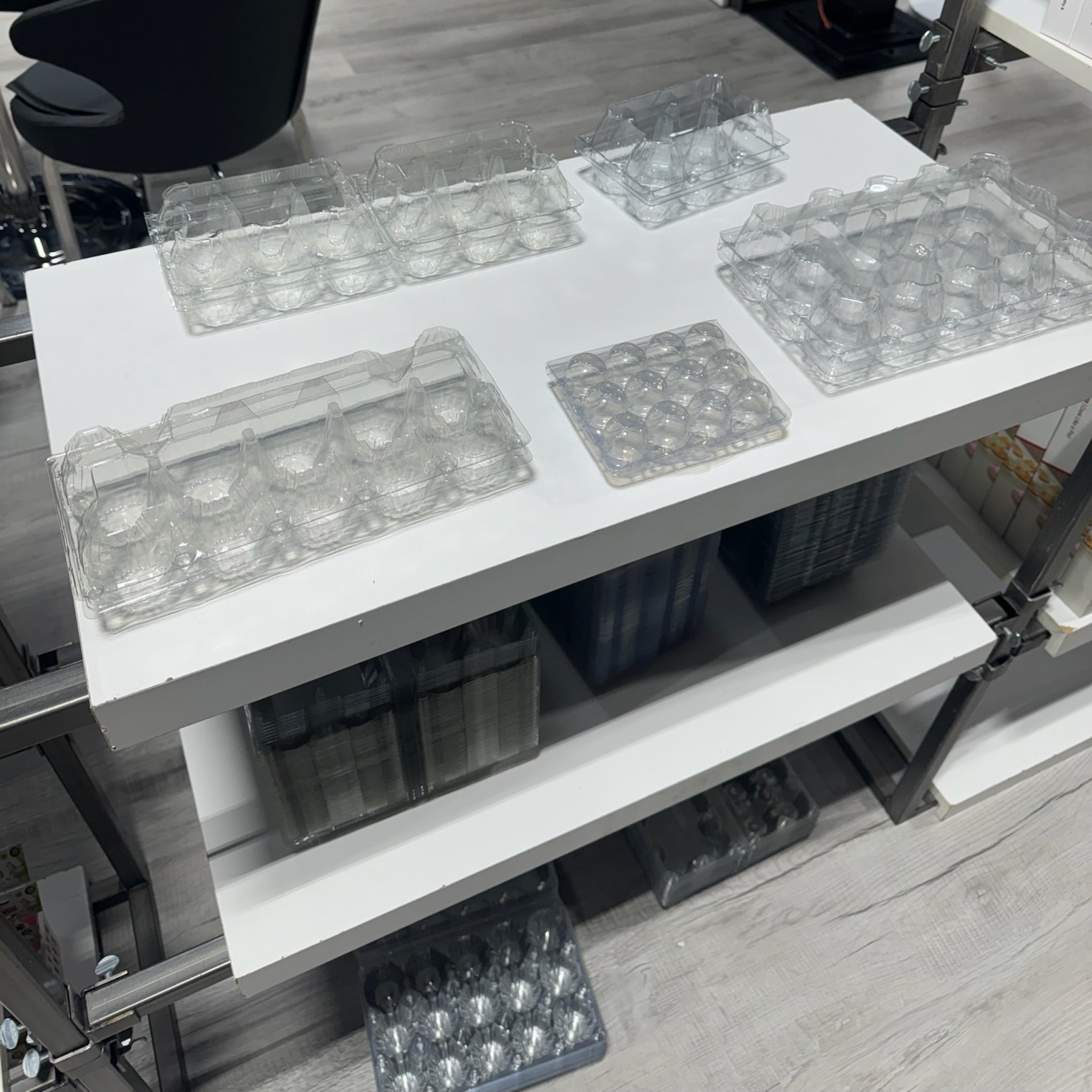 Transparent plastic egg carton designed to hold a dozen chicken eggs